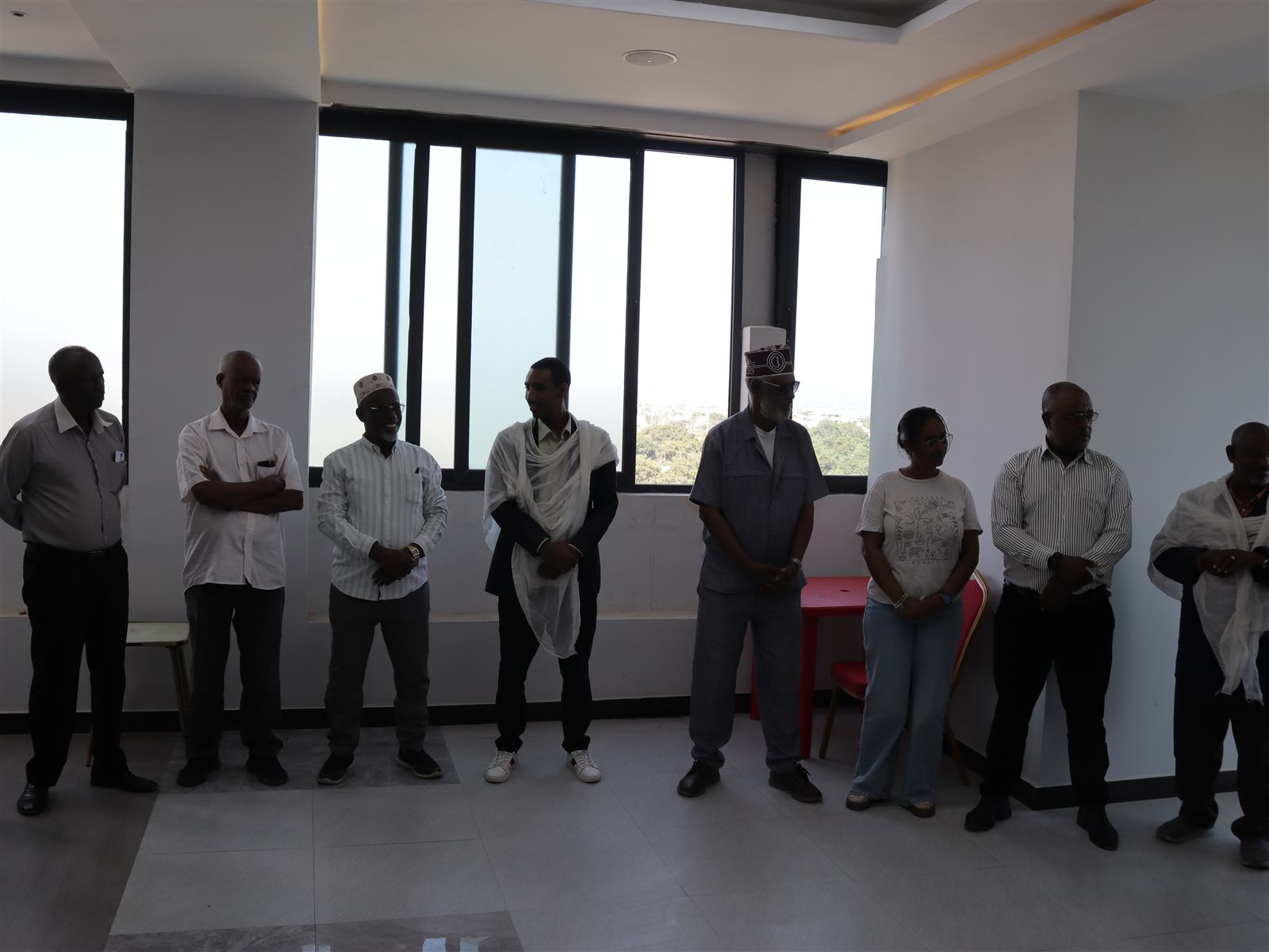 Full group of training participants standing together in the hotel meeting room