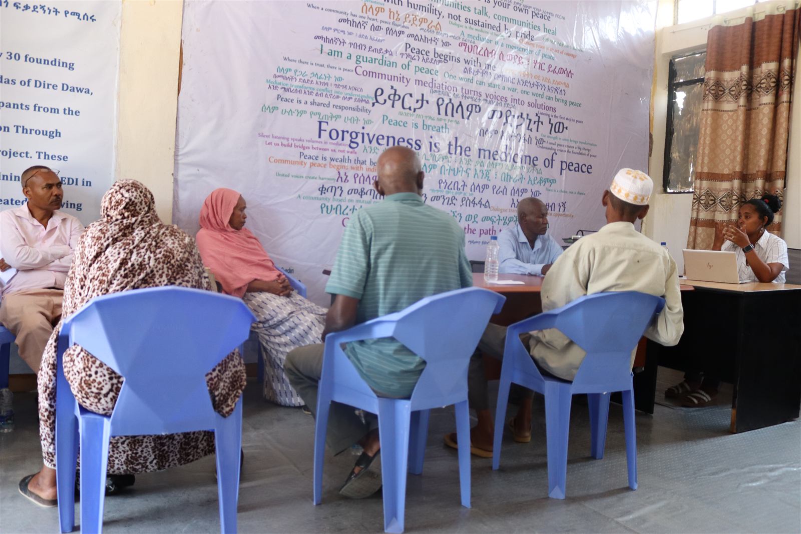 A wider view of the hub meeting room during a case discussion